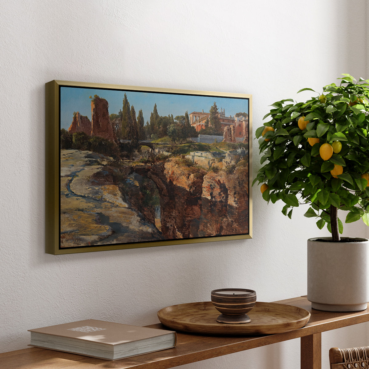 Palatine in Rome, c. 1921 by Edward Theodore Compton, presented in a gold floater framed canvas featuring historic Roman ruins and buildings set within warm landscape, displayed above a hallway console table.
