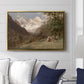 Landscape in the Caucasus, c. 1921 by Edward Theodore Compton displayed above a sofa in a living room in a gold floater frame, featuring an expansive view of Caucasus mountains under open sky.