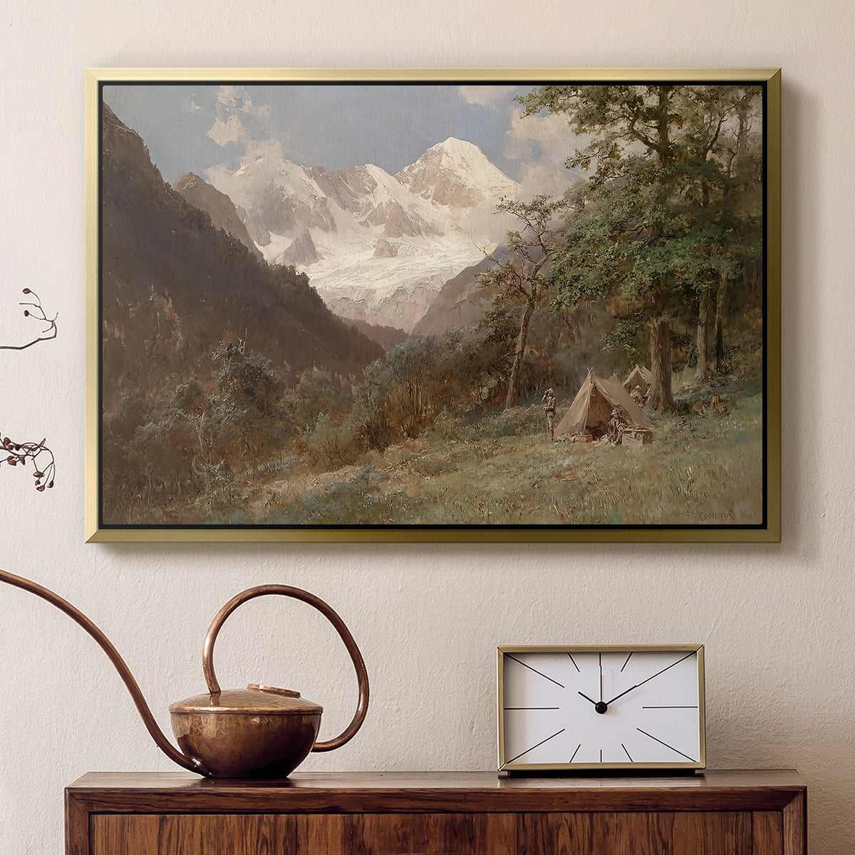 Gold floater framed canvas featuring a natural scene with valleys and rocky formations, displayed above a cabinet in a soft-toned living room.