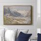 Shepherds (Pasterze), c. 1921 by Edward Theodore Compton displayed above a sofa in a living room in a gold floater frame, featuring a pastoral mountain scene with figures tending livestock.