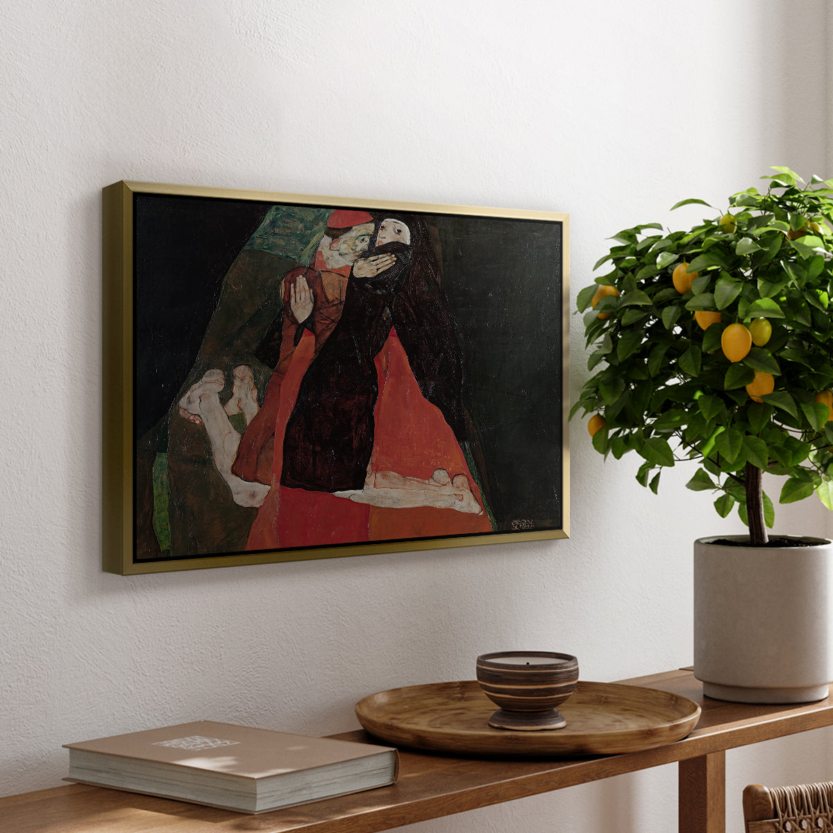 Cardinal and Nun (Caress), 1912 by Egon Schiele, presented in a gold floater framed canvas featuring two figures embracing intimately in stylized expressionist composition, displayed above a hallway console table.