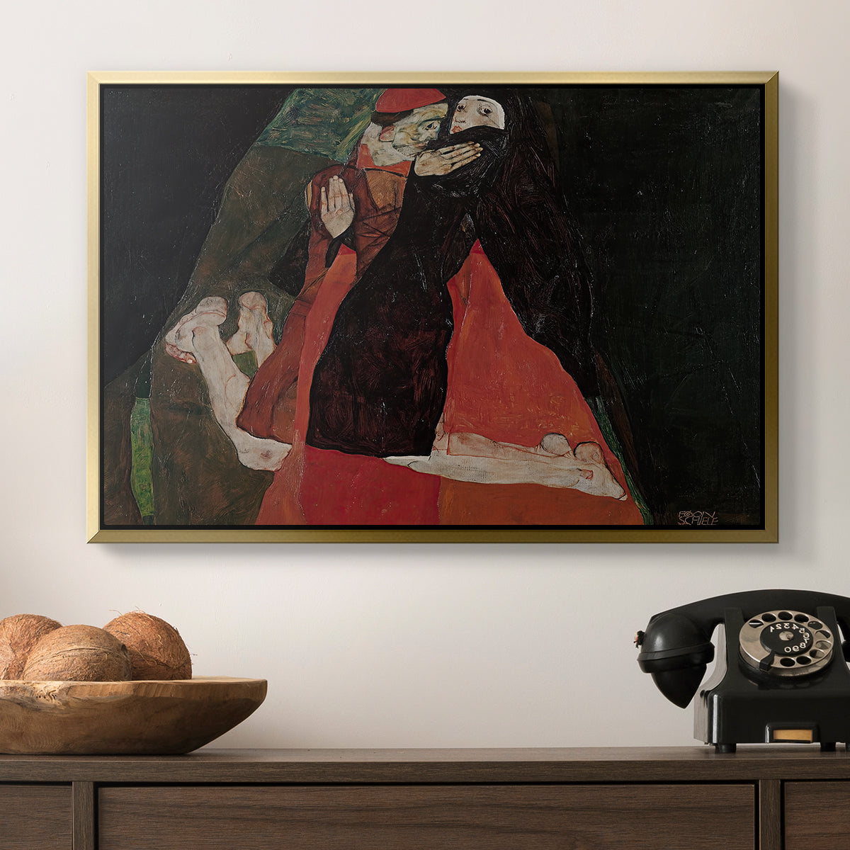 Cardinal and Nun (Caress), 1912 by Egon Schiele in a gold floater framed canvas displayed above a console table in a hallway, featuring an intimate scene with religious figures in modernist style.
