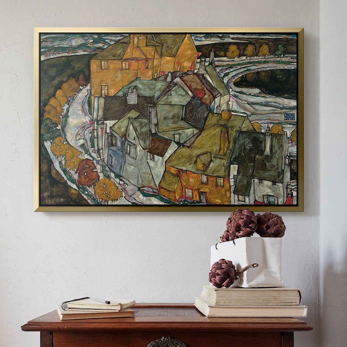 Gold floater framed canvas featuring Crescent of Houses II (Island Town), 1915 by Egon Schiele above an entryway table in a minimalist foyer.