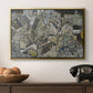 Mödling II, 1918 by Egon Schiele in a gold floater framed canvas displayed above a console table in a hallway, featuring a stylized urban composition with geometric structures and muted tones.