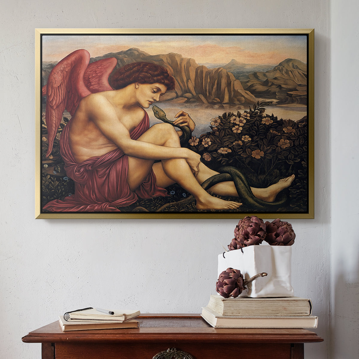 Gold floater framed canvas featuring The Angel with the Serpent, c. 1870-1875 by Evelyn De Morgan above an entryway table in a minimalist foyer.