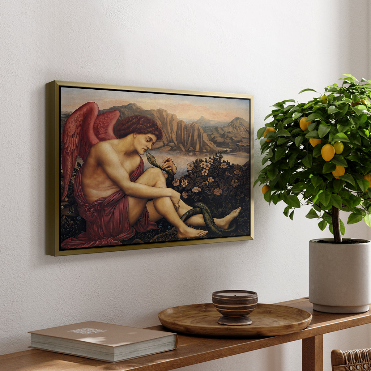 The Angel with the Serpent, c. 1870-1875 by Evelyn De Morgan, presented in a gold floater framed canvas featuring an angelic figure confronting serpent in symbolic battle of good and evil, displayed above a hallway console table.