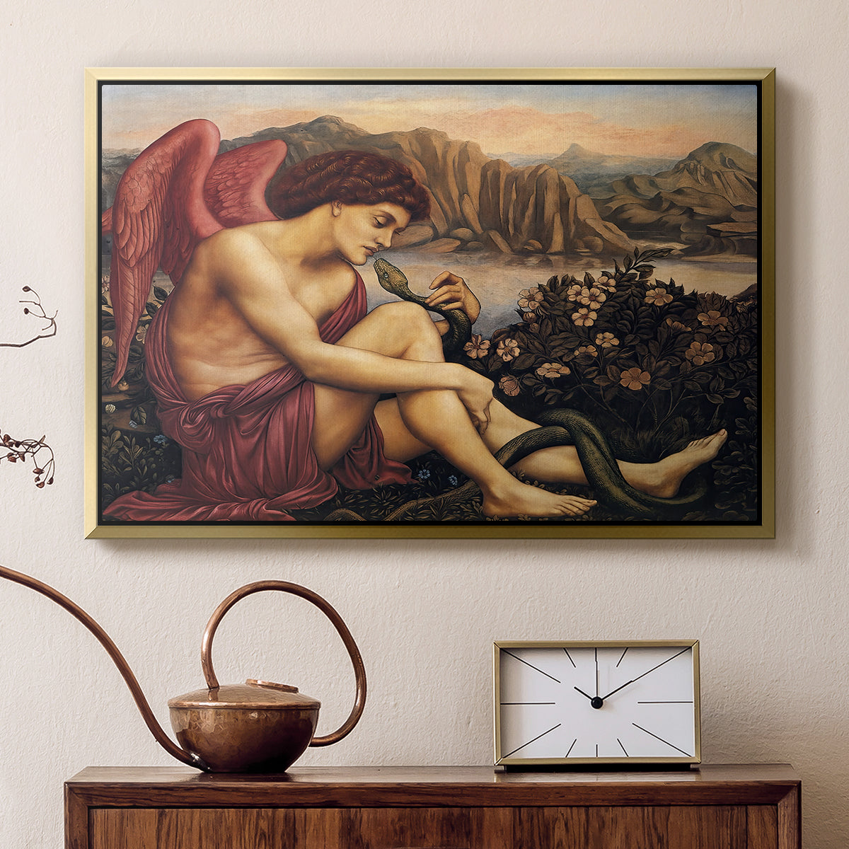 Gold floater framed canvas featuring a religious scene with angel defeating snake in dramatic pose, displayed above a cabinet in a soft-toned living room.
