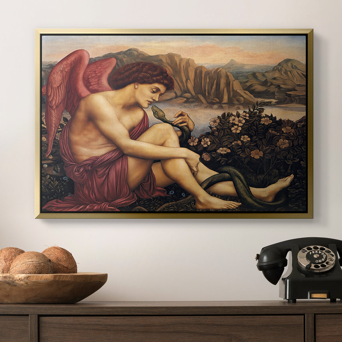 The Angel with the Serpent, c. 1870-1875 by Evelyn De Morgan in a gold floater framed canvas displayed above a console table in a hallway, featuring a symbolic imagery of purity overcoming evil forces.