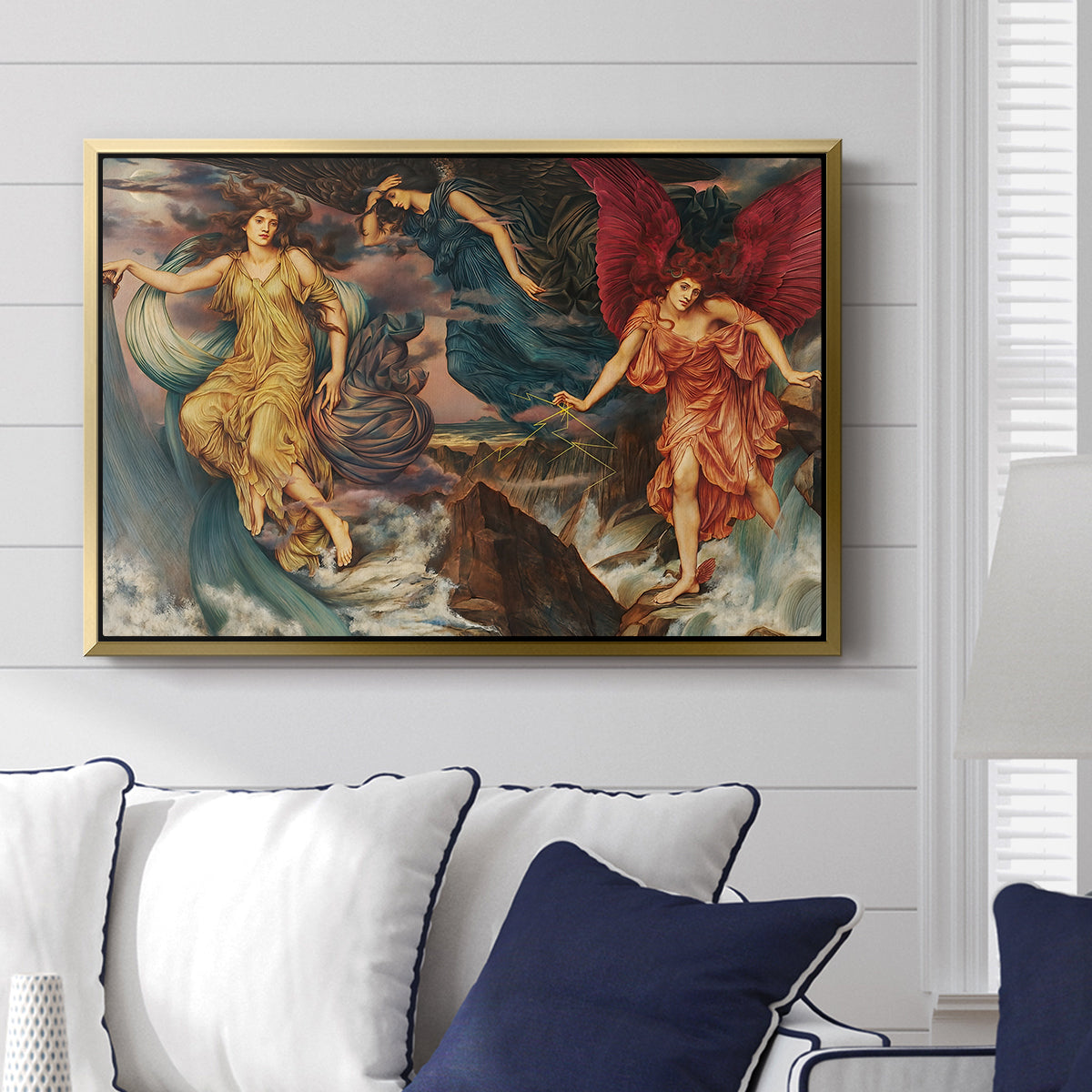 The Storm Spirits, 1900 by Evelyn De Morgan displayed above a sofa in a living room in a gold floater frame, featuring a dramatic allegory of spirits moving within turbulent sky.