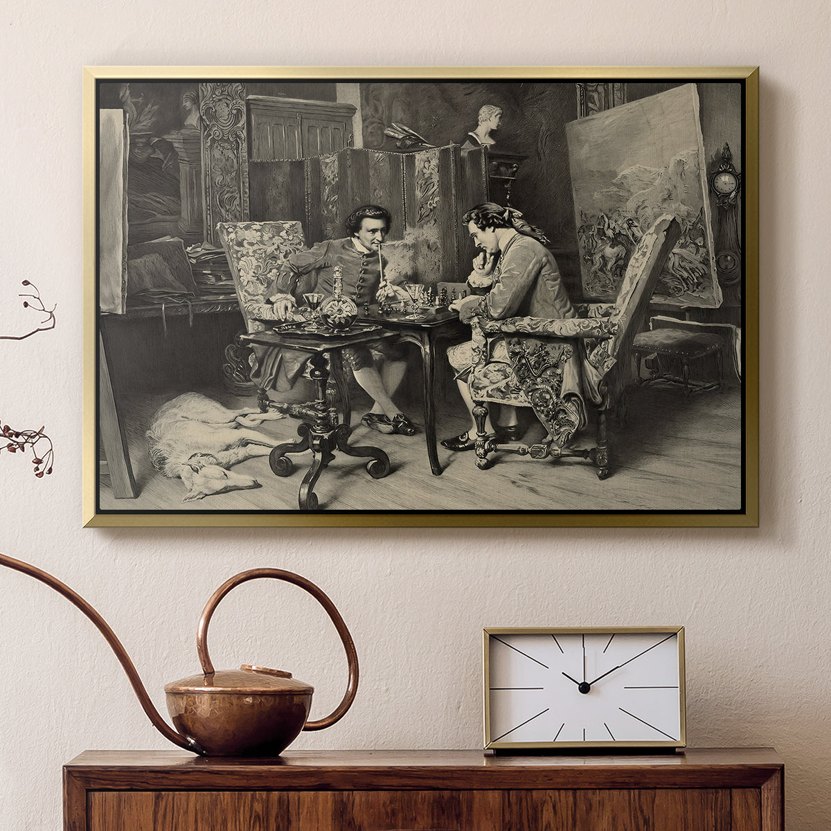 Gold floater framed canvas featuring an intimate interior with players focused on board and pieces, displayed above a cabinet in a soft-toned living room.