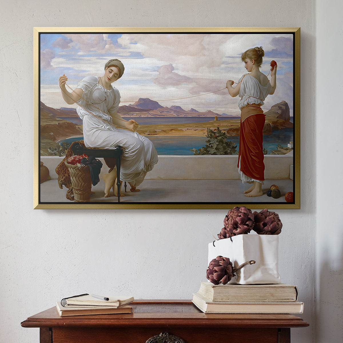Gold floater framed canvas featuring Winding the Skein, c. 1878 by Frederic Leighton above an entryway table in a minimalist foyer.