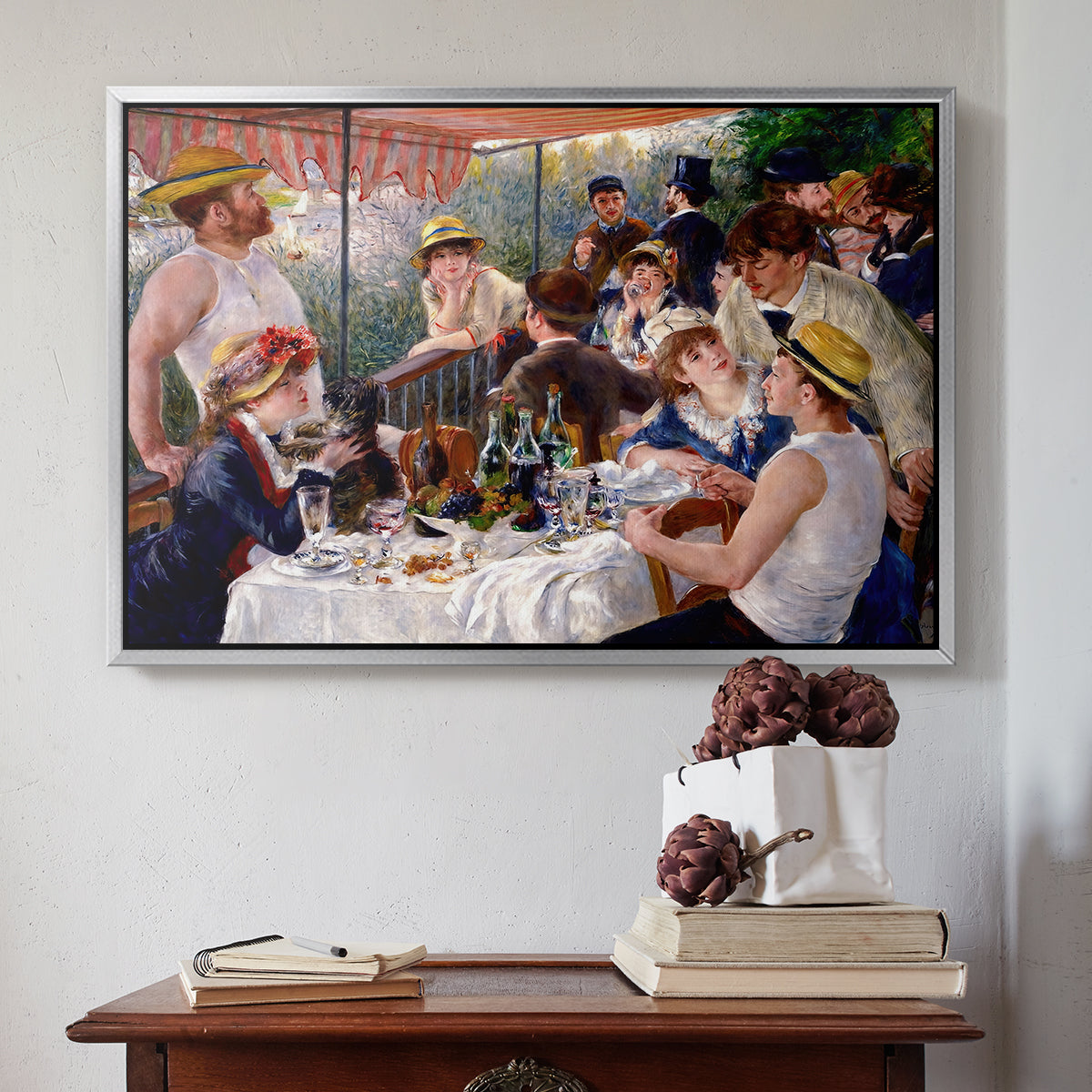 Silver floater framed canvas featuring Luncheon of the Boating Party (Le Déjeuner des canotiers), 1880-1881 by Pierre-Auguste Renoir above an entryway table in a minimalist foyer.