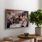 Luncheon of the Boating Party (Le Déjeuner des canotiers), 1880-1881 by Pierre-Auguste Renoir, presented in a silver floater framed canvas featuring a group of elegantly dressed people dining together on a sunlit balcony overlooking the river, displayed above a hallway console table.
