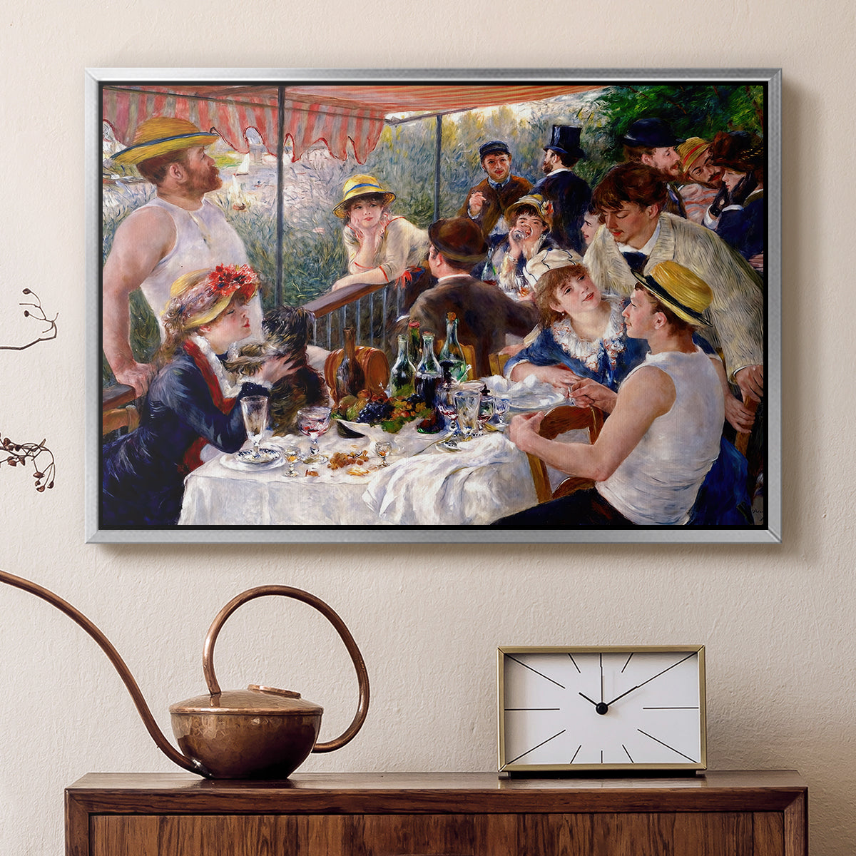 Silver floater framed canvas featuring an impressionist scene of friends enjoying lunch with wine and conversation, displayed above a cabinet in a soft-toned living room.