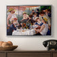 Luncheon of the Boating Party (Le Déjeuner des canotiers), 1880-1881 by Pierre-Auguste Renoir in a silver floater framed canvas displayed above a console table in a hallway, featuring a social dining scene with figures seated around table on riverside terrace.