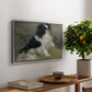 Tama, the Japanese Dog, c. 1876 by Pierre-Auguste Renoir, presented in a silver floater framed canvas featuring a small black and white dog standing in shallow water with soft brushstrokes, displayed above a hallway console table.