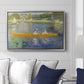 The Skiff (La Yole), 1875 by Pierre-Auguste Renoir displayed above a sofa in a living room in a silver floater frame, featuring an impressionist boating scene with people relaxing in a narrow skiff.