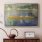Silver floater framed canvas featuring a couple seated in boat on river surrounded by soft reflections, displayed above a cabinet in a soft-toned living room.