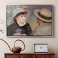 Silver floater framed canvas featuring an impressionist depiction of couple enjoying leisure time near water, displayed above a cabinet in a soft-toned living room.