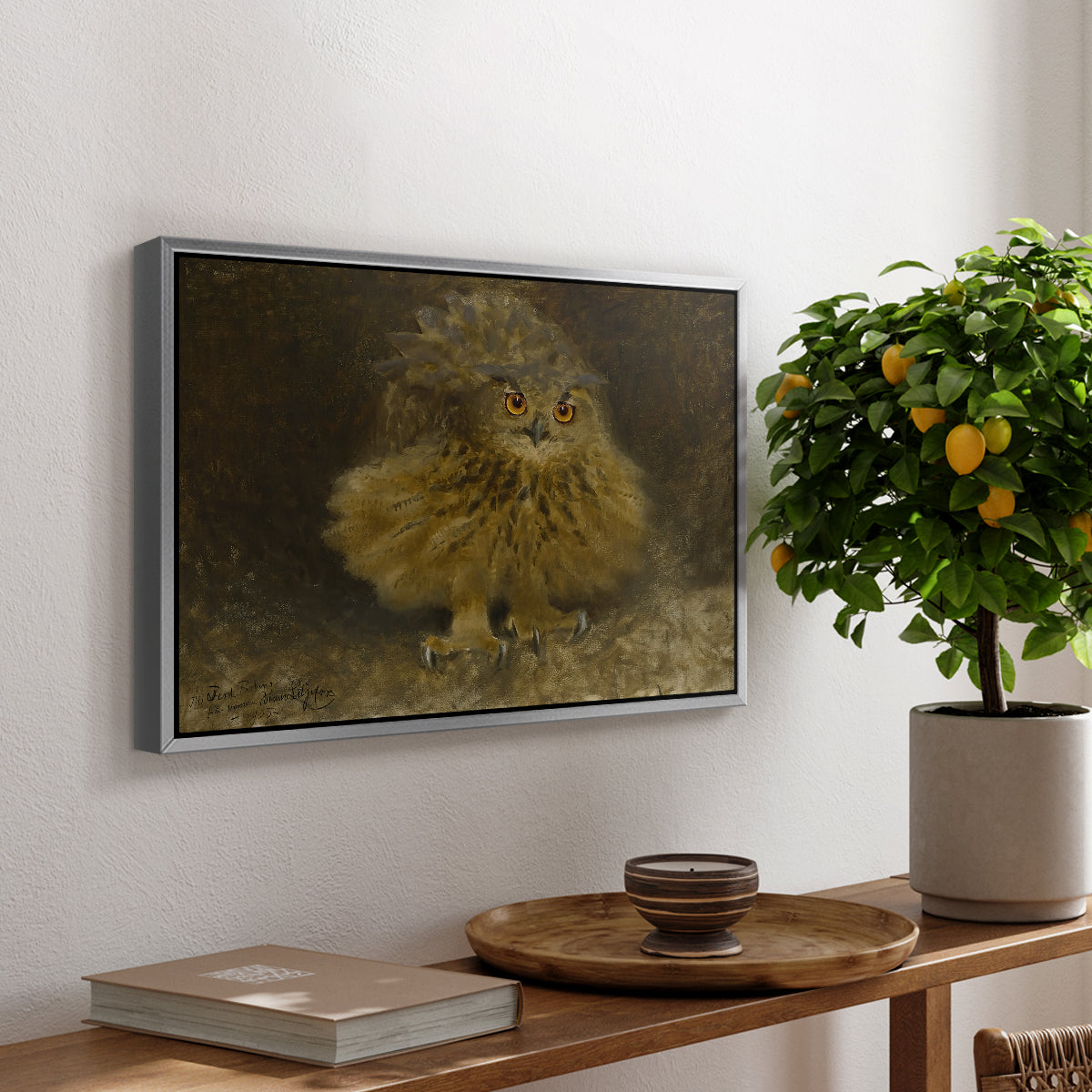 An Eagle Owl (Berguv), 1905 by Bruno Liljefors, presented in a silver floater framed canvas featuring a large owl perched on branch in shadowy natural forest setting, displayed above a hallway console table.