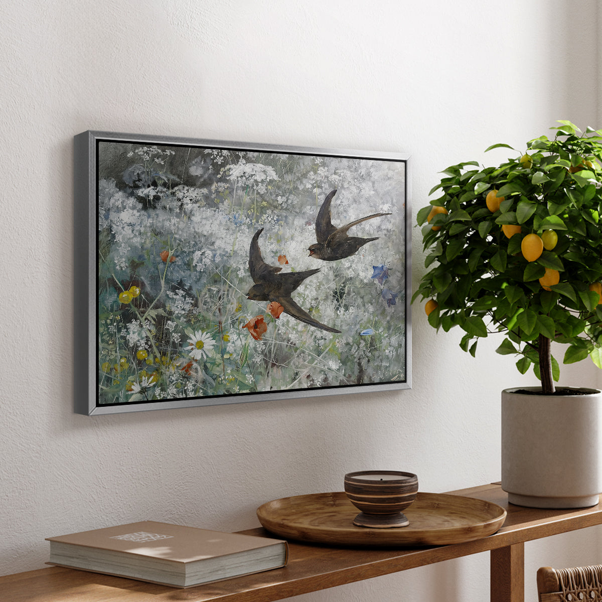 Common Swifts, 1886 by Bruno Liljefors, presented in a silver floater framed canvas featuring a flock of birds in flight soaring across open sky above landscape, displayed above a hallway console table.