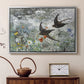 Silver floater framed canvas featuring a multiple birds flying together in natural outdoor scene, displayed above a cabinet in a soft-toned living room.