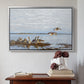 Silver floater framed canvas featuring Greylag Geese (Grågäss), 1922 by Bruno Liljefors above an entryway table in a minimalist foyer.