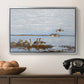 Greylag Geese (Grågäss), 1922 by Bruno Liljefors in a silver floater framed canvas displayed above a console table in a hallway, featuring a flock of geese positioned along marshy terrain.