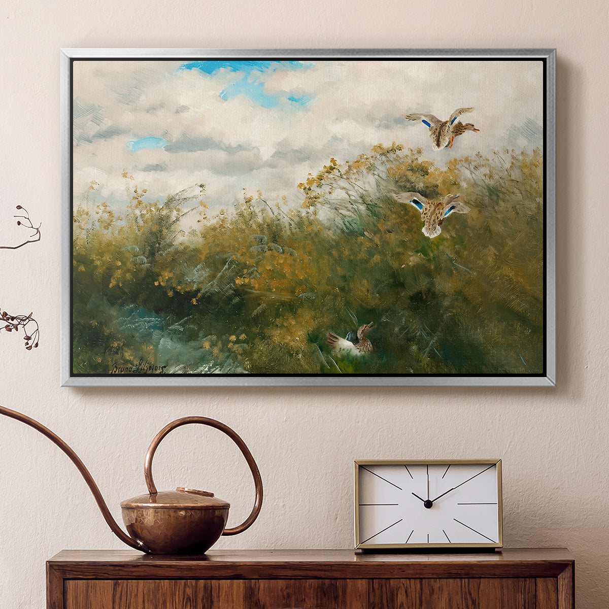 Silver floater framed canvas featuring a group of ducks foraging in natural marsh setting, displayed above a cabinet in a soft-toned living room.