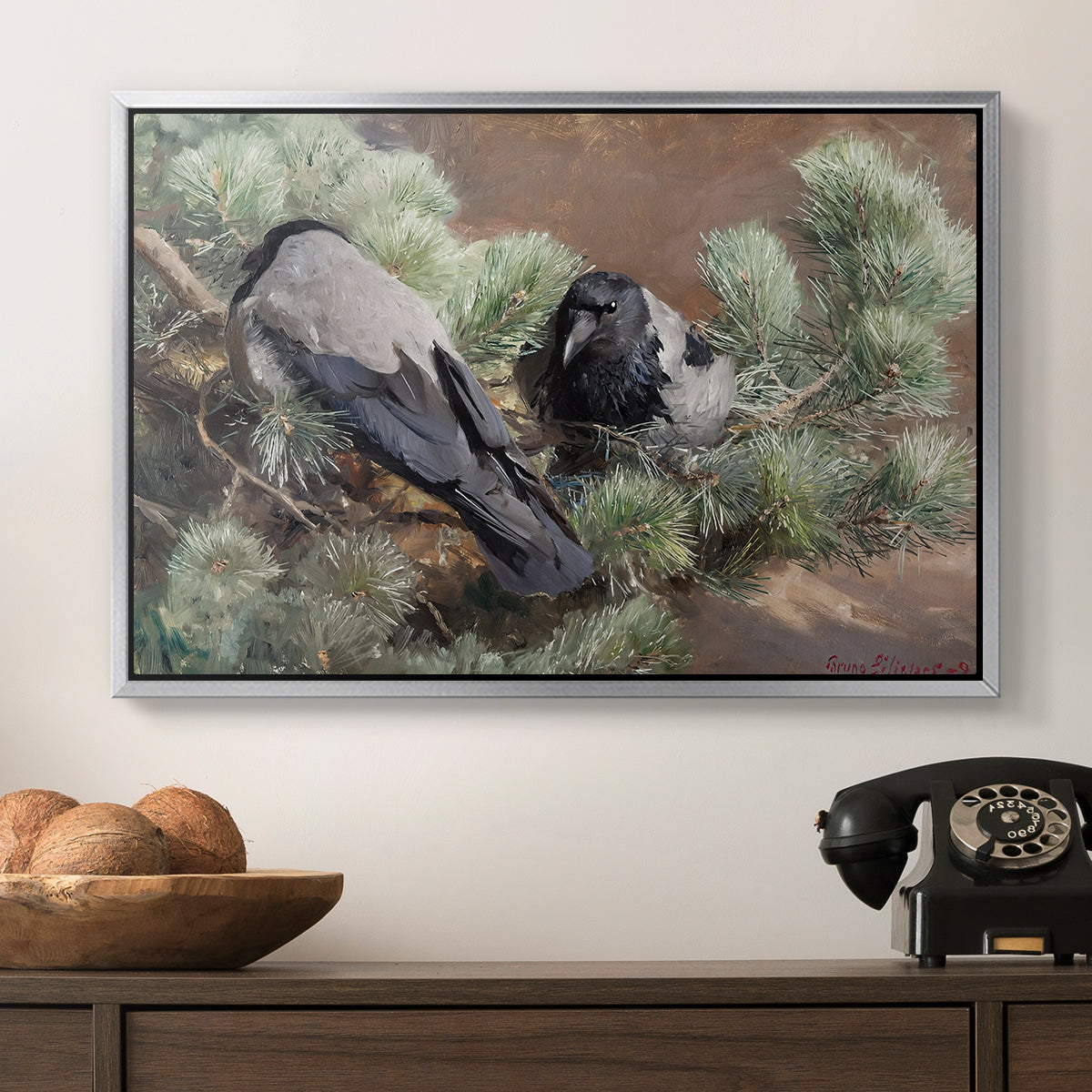 Hooded Crows (Kråkor), 1891 by Bruno Liljefors in a silver floater framed canvas displayed above a console table in a hallway, featuring a wildlife painting of dark birds against muted landscape.