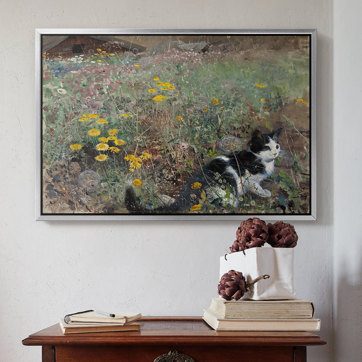 Silver floater framed canvas featuring Cat on a Flowery Meadow, 1887 by Bruno Liljefors above an entryway table in a minimalist foyer.