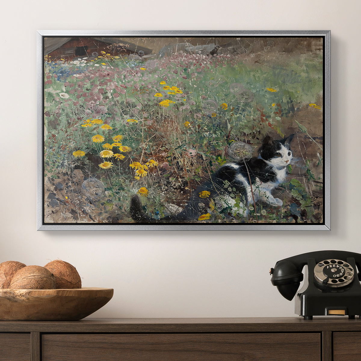 Cat on a Flowery Meadow, 1887 by Bruno Liljefors in a silver floater framed canvas displayed above a console table in a hallway, featuring a naturalistic depiction of cat in blooming countryside setting.