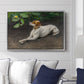 Portrait of a Dog, 1891 by Bruno Liljefors displayed above a sofa in a living room in a silver floater frame, featuring a realistic portrait of a resting dog with attentive expression.