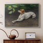 Silver floater framed canvas featuring an animal painting of dog stretched out on earthy terrain, displayed above a cabinet in a soft-toned living room.