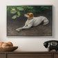Portrait of a Dog, 1891 by Bruno Liljefors in a silver floater framed canvas displayed above a console table in a hallway, featuring a calm scene of dog reclining in open landscape.