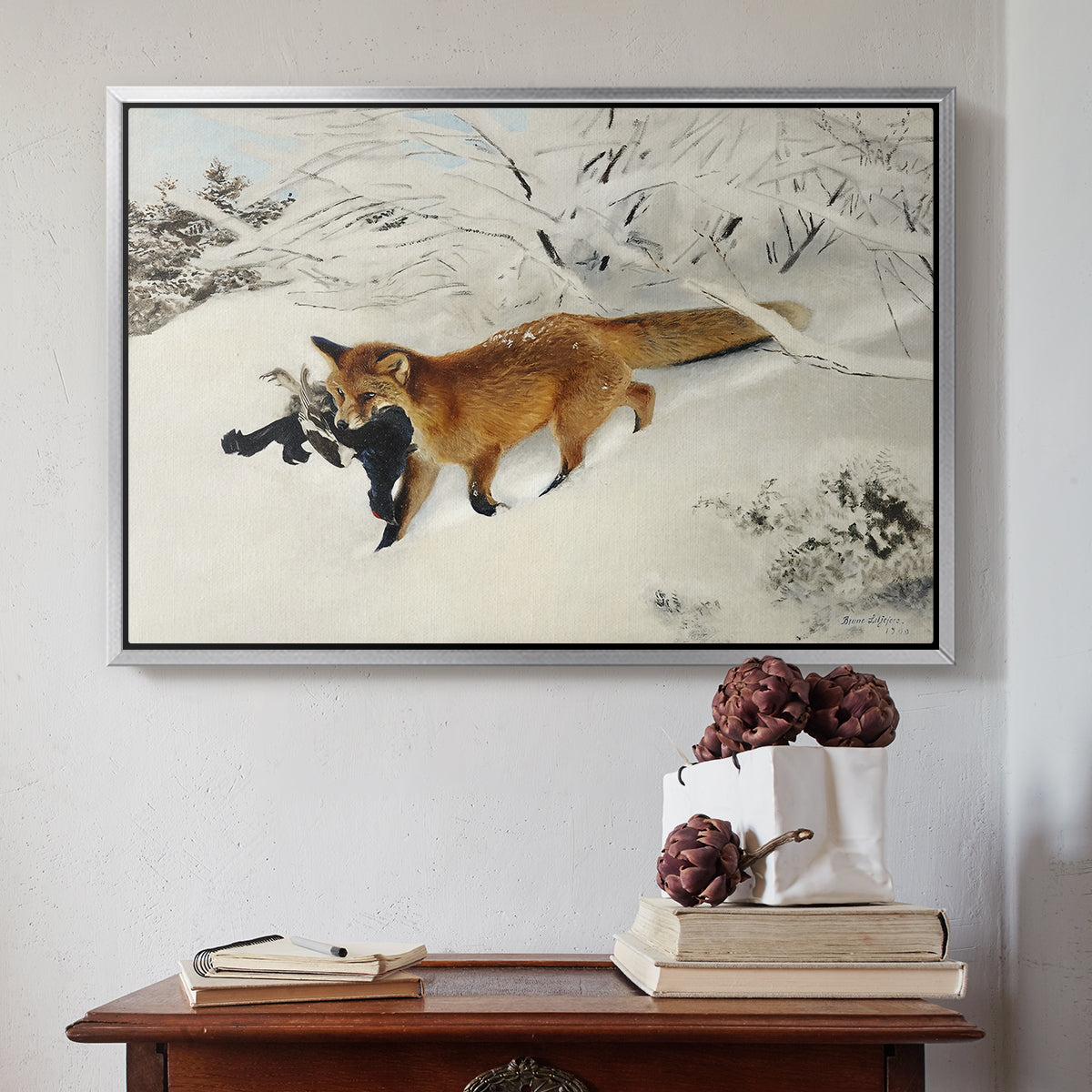 Silver floater framed canvas featuring Fox in Snow Landscape, 1900 by Bruno Liljefors above an entryway table in a minimalist foyer.