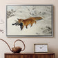 Silver floater framed canvas featuring a red fox crossing snow-covered ground under pale sky, displayed above a cabinet in a soft-toned living room.