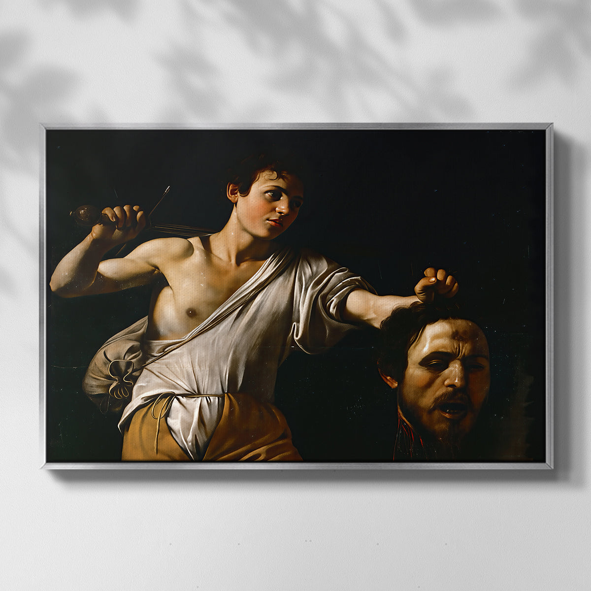 Front view of David with the Head of Goliath (Vienna Version), c. 1607 by Caravaggio in a silver floater framed canvas.