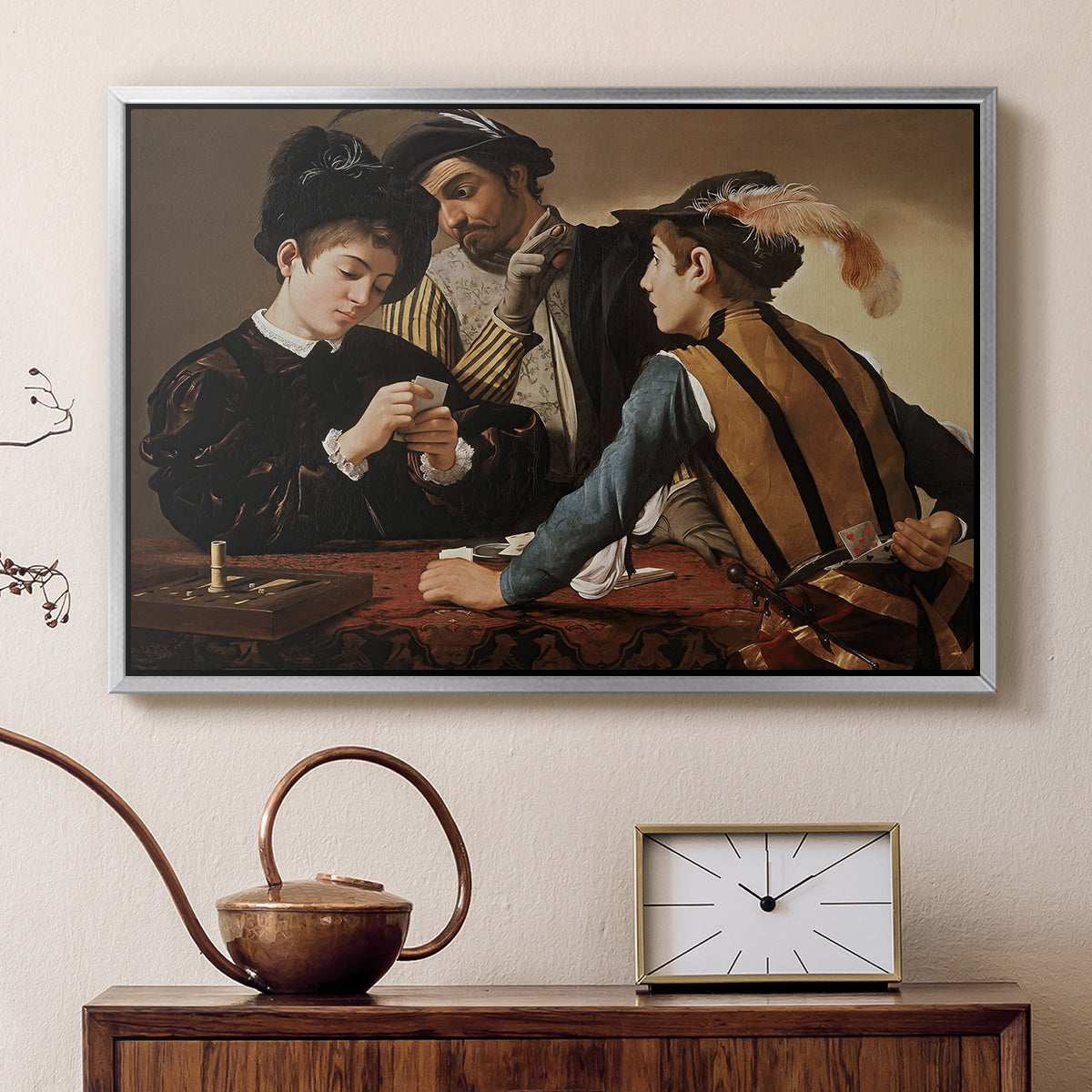 Silver floater framed canvas featuring a young men playing cards with one cheating and another watching closely, displayed above a cabinet in a soft-toned living room.