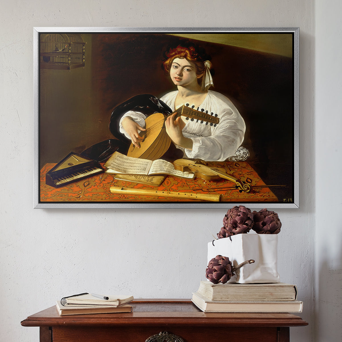 Silver floater framed canvas featuring The Lute Player (Wildenstein Version), c. 1596 by Caravaggio above an entryway table in a minimalist foyer.