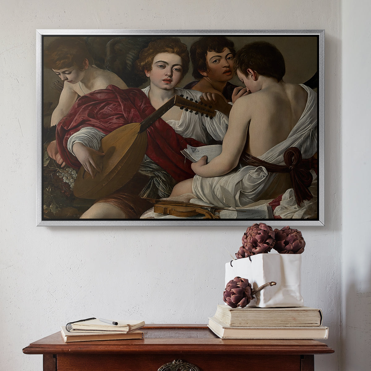 Silver floater framed canvas featuring The Musicians, c. 1595 by Caravaggio above an entryway table in a minimalist foyer.