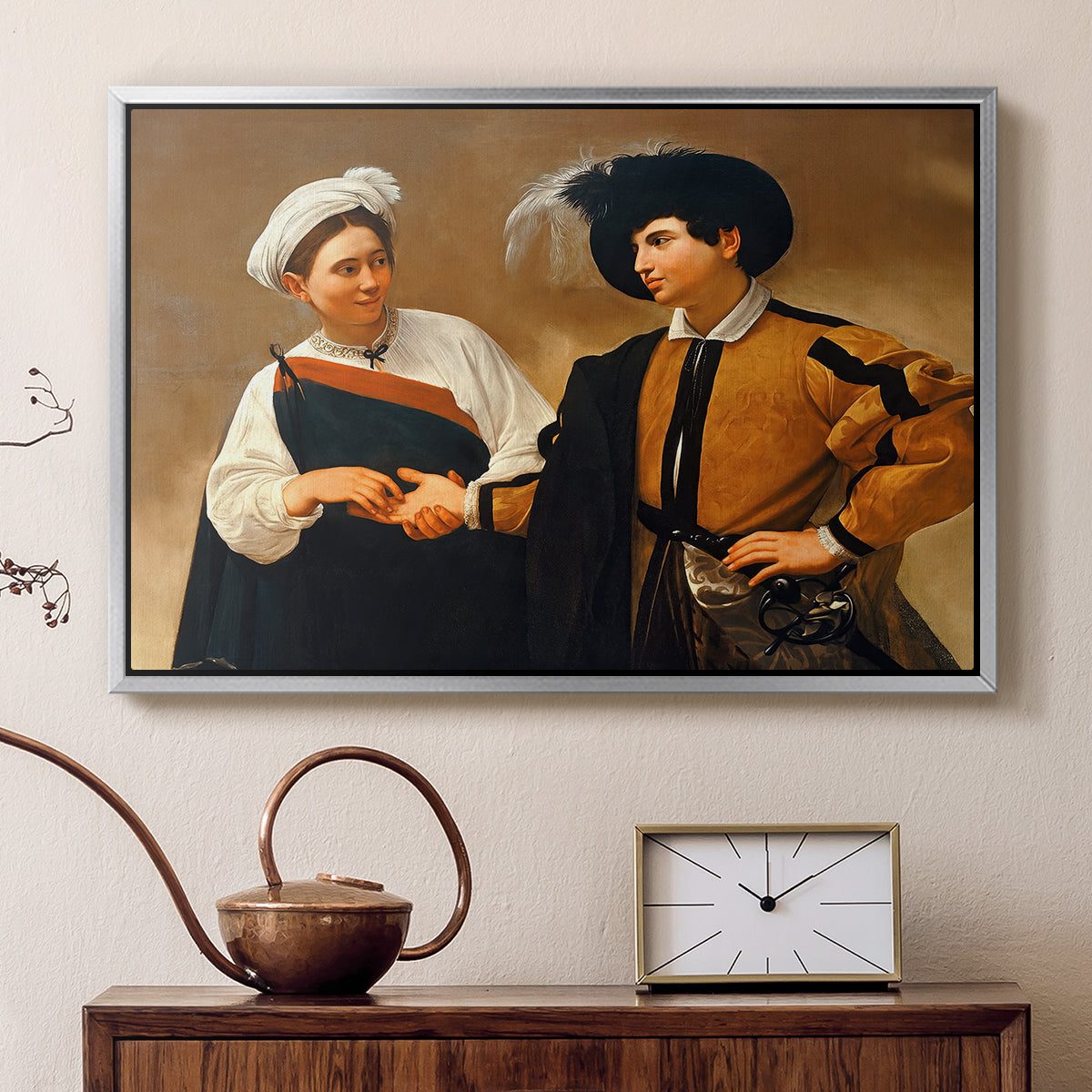 Silver floater framed canvas featuring a close interaction between two figures involving deception and gesture, displayed above a cabinet in a soft-toned living room.