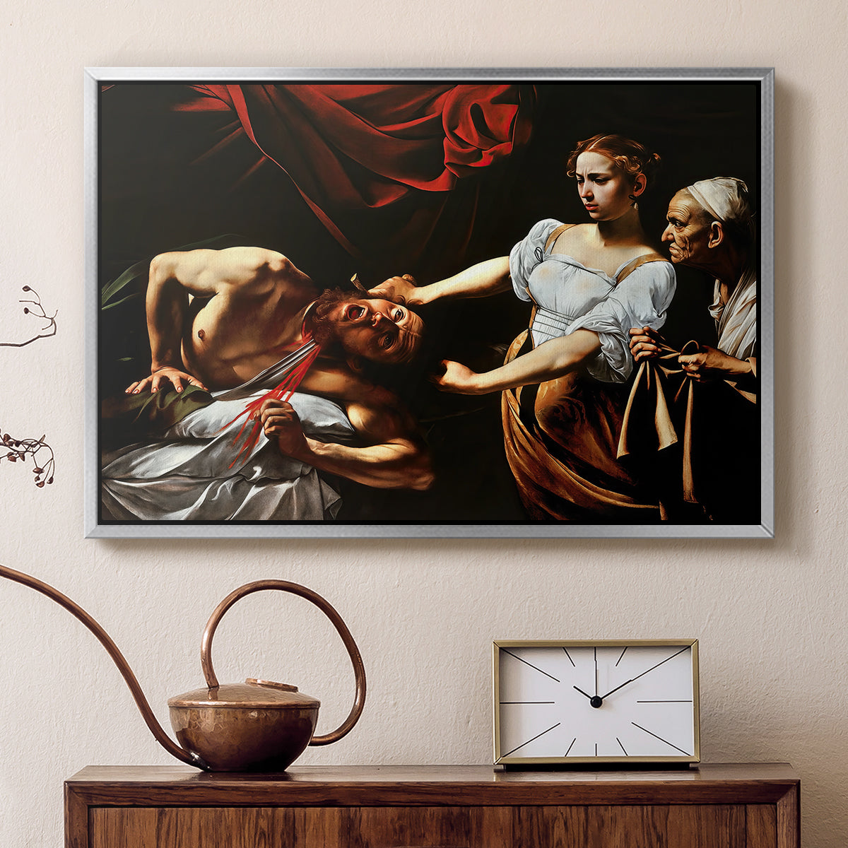 Silver floater framed canvas featuring an intense moment of Judith slaying Holofernes with sword, displayed above a cabinet in a soft-toned living room.