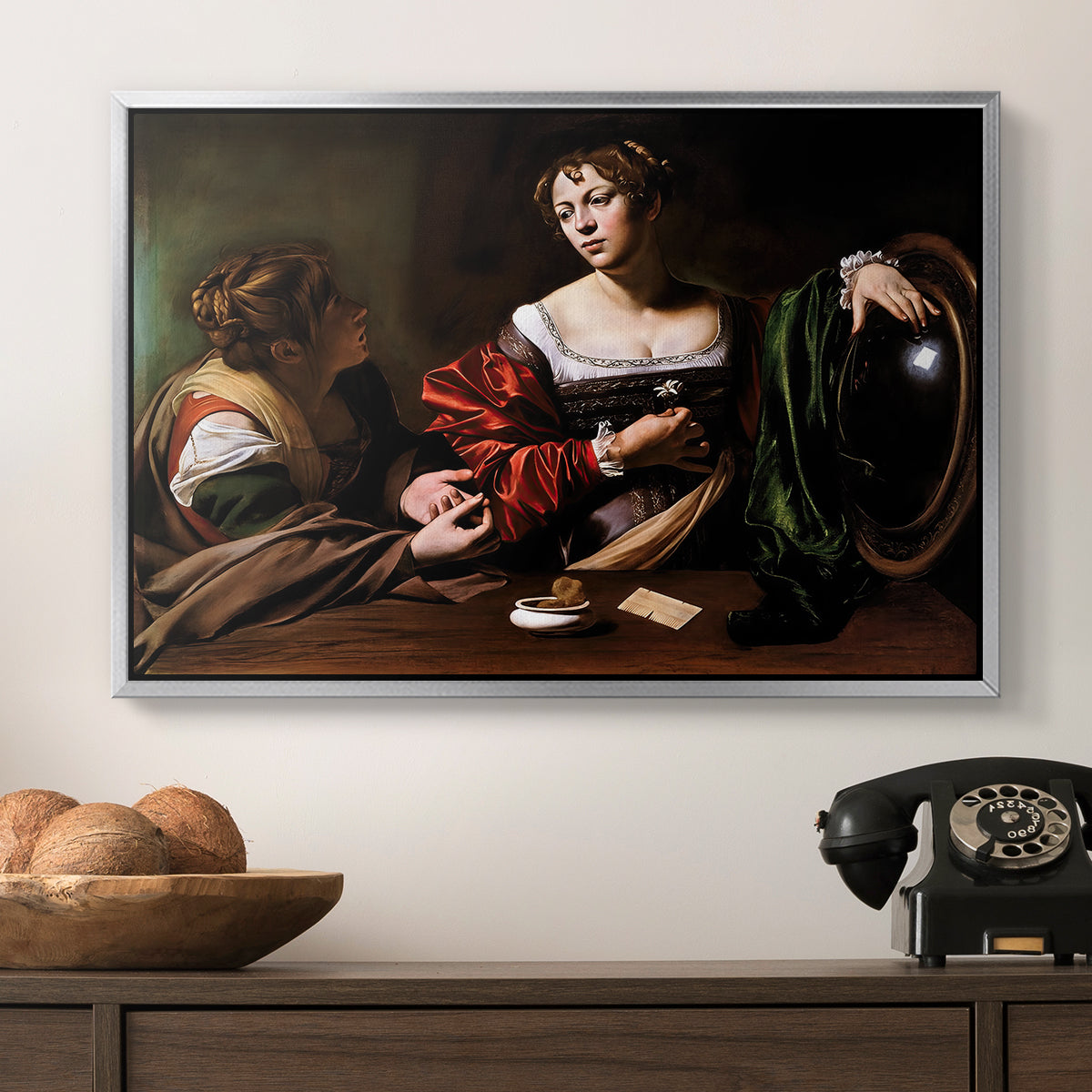 Martha and Mary Magdalene, c. 1598 by Caravaggio in a silver floater framed canvas displayed above a console table in a hallway, featuring a religious interior scene with figures engaged in thoughtful dialogue.