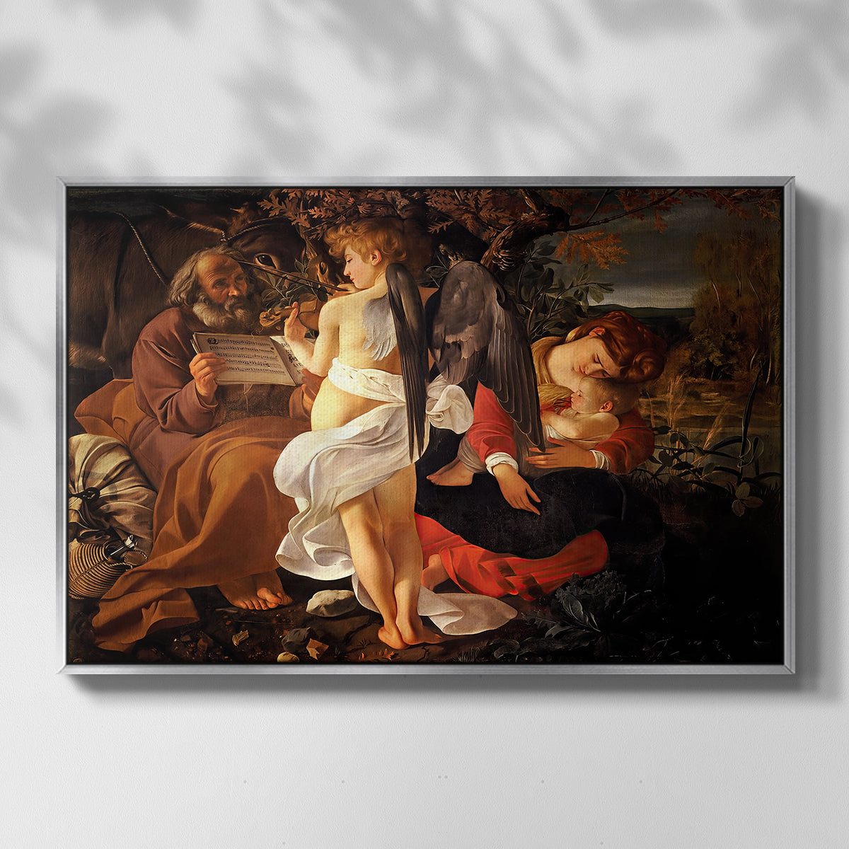 Front view of Rest on the Flight into Egypt, c. 1597 by Caravaggio in a silver floater framed canvas.