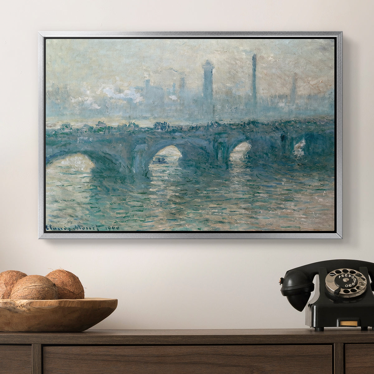 Waterloo Bridge, Gray Weather, 1900 by Claude Monet in a silver floater framed canvas displayed above a console table in a hallway, featuring an atmospheric urban landscape with misty light and reflections.