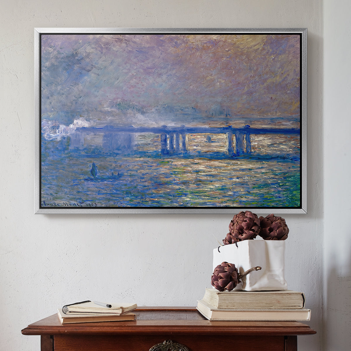 Silver floater framed canvas featuring Charing Cross Bridge, 1903 by Claude Monet above an entryway table in a minimalist foyer.