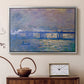 Silver floater framed canvas featuring an atmospheric depiction of London bridge with reflections in water, displayed above a cabinet in a soft-toned living room.