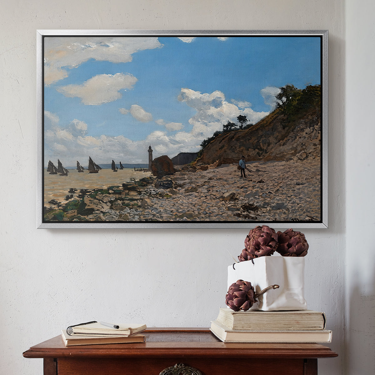 Silver floater framed canvas featuring The Beach at Honfleur, 1864 by Claude Monet above an entryway table in a minimalist foyer.