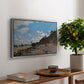 The Beach at Honfleur, 1864 by Claude Monet, presented in a silver floater framed canvas featuring a coastal beach scene with figures gathered along shoreline and boats nearby, displayed above a hallway console table.